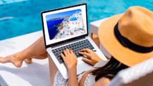 Woman relaxing on a beach in Italy with a laptop, symbolizing earning income through Amazon affiliate links while traveling.